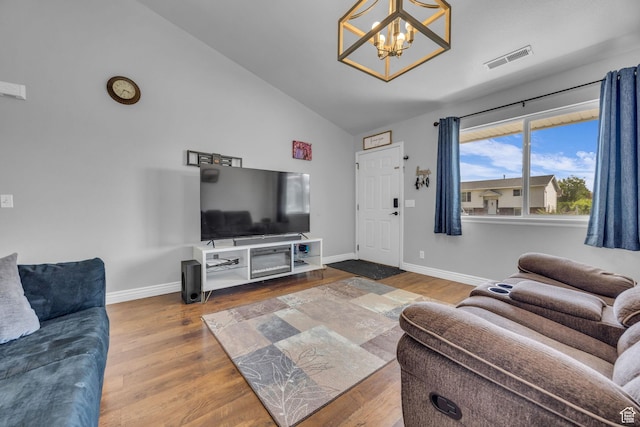 556 E 800 N, Ogden, UT 84404 - living room featuring a chandelier, vaulted ceiling, wood finished floors, and baseboards