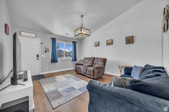 556 E 800 N, Ogden, UT 84404 - living room featuring a chandelier, wood finished floors, baseboards, and lofted ceiling