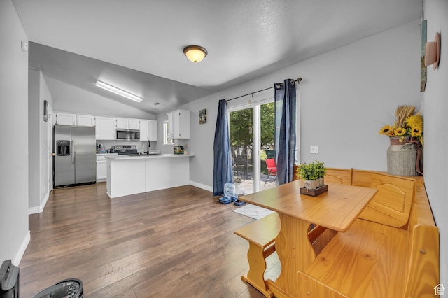 556 E 800 N, Ogden, UT 84404 - dining room featuring lofted ceiling, dark wood-type flooring, and baseboards