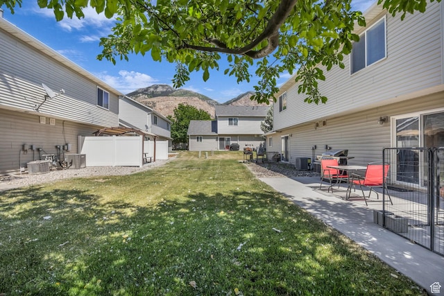 556 E 800 N, Ogden, UT 84404 - view of yard featuring a mountain view, a patio, and cooling unit