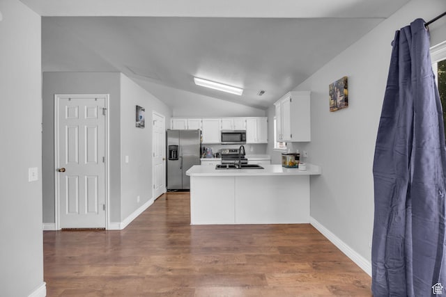 556 E 800 N, Ogden, UT 84404 - kitchen with appliances with stainless steel finishes, a peninsula, a sink, lofted ceiling, and white cabinets