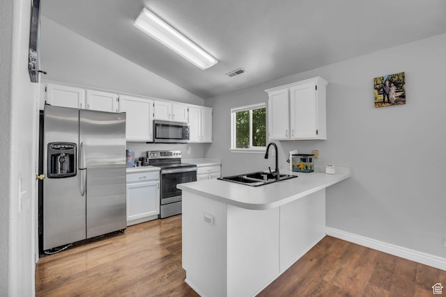 556 E 800 N, Ogden, UT 84404 - kitchen with stainless steel appliances, lofted ceiling, a sink, a peninsula, and white cabinets