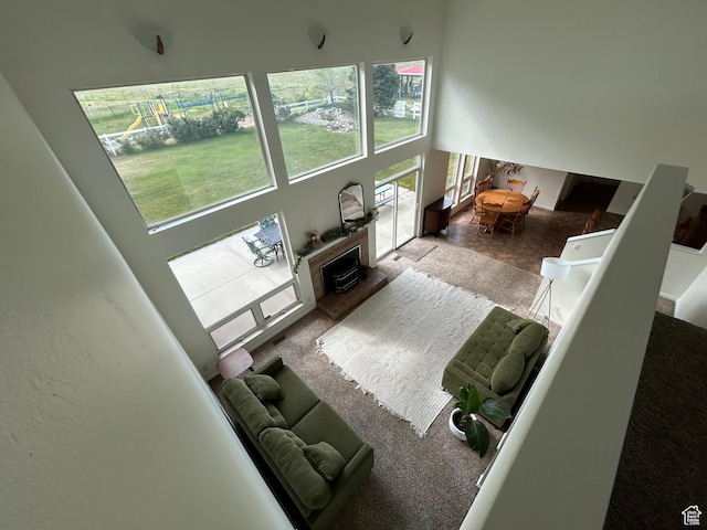 4306 Elk Ln, Erda, UT 84074 - carpeted living room featuring a towering ceiling and a fireplace with raised hearth