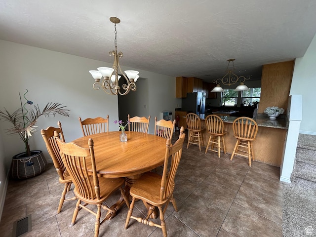 4306 Elk Ln, Erda, UT 84074 - dining room featuring a chandelier, baseboards, and a textured ceiling