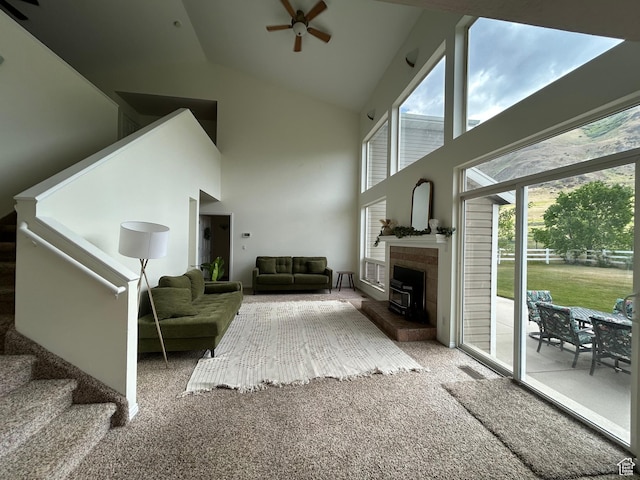 4306 Elk Ln, Erda, UT 84074 - carpeted living room featuring high vaulted ceiling, a ceiling fan, and stairs