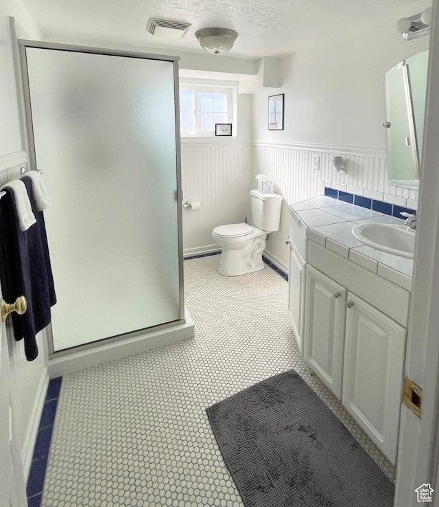 975 S Canyon Breeze E, Draper, UT 84020 - bathroom featuring vanity, a shower stall, toilet, and a wainscoted wall