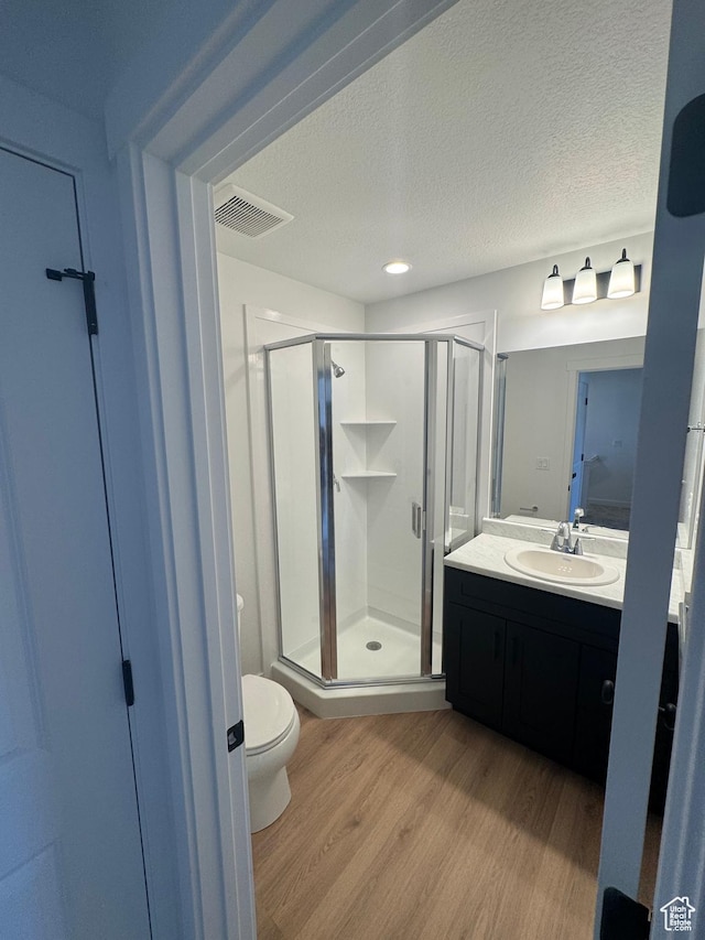 1650 N Main St N Unit 125, Layton, UT 84041 - full bath with wood finished floors, a stall shower, vanity, and a textured ceiling