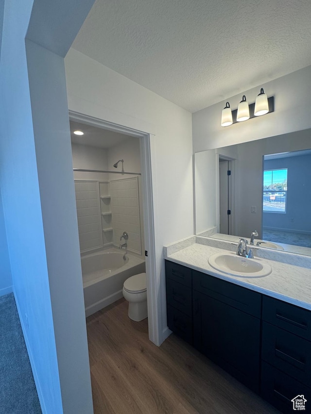 1650 N Main St N Unit 125, Layton, UT 84041 - bathroom featuring wood finished floors, vanity, bathing tub / shower combination, and a textured ceiling