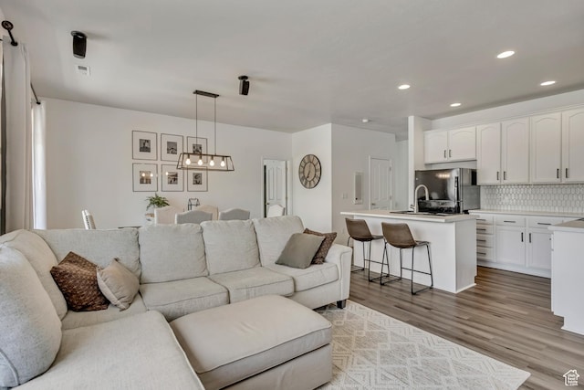 7284 S Brittany Park Ave, West Jordan, UT 84084 - living room featuring wood finished floors and recessed lighting