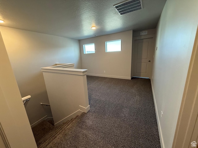 757 W Lone Pine Ln Unit 337, Mapleton, UT 84664 - hallway with an upstairs landing, a textured ceiling, baseboards, and dark colored carpet