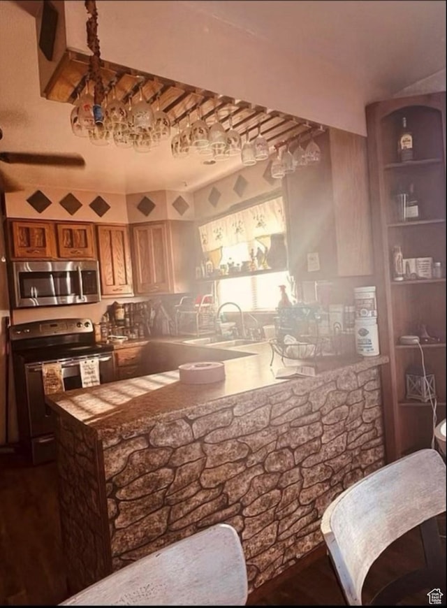 5293 N 6150 W, Roosevelt, UT 84066 - bar area featuring stainless steel microwave, electric range oven, a sink, and wood finished floors