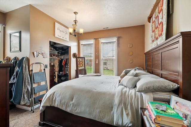1183 S Hoytsville Rd Unit A, Hoytsville, UT 84017 - bedroom featuring carpet flooring, a closet, access to exterior, and a chandelier