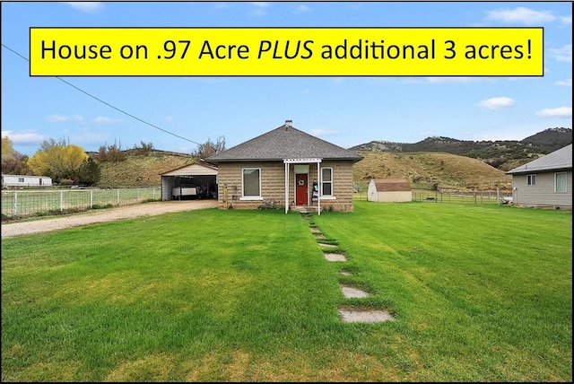 1183 S Hoytsville Rd Unit A, Hoytsville, UT 84017 - view of front of home with driveway, an outdoor structure, a carport, stone siding, and a mountain view