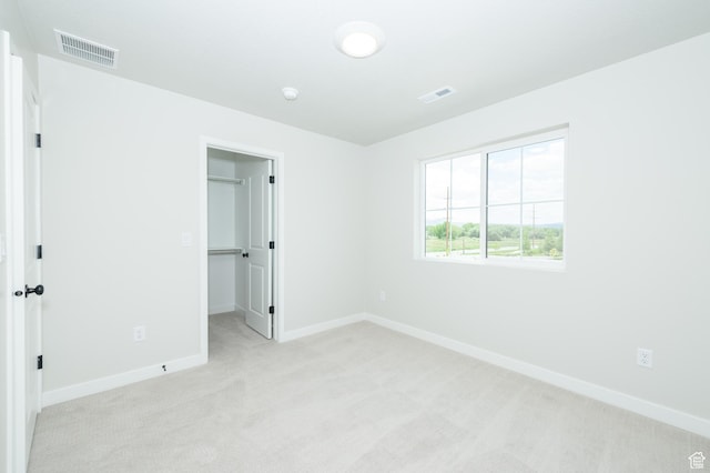 166 N Husker Ln, Saratoga Springs, UT 84045 - unfurnished bedroom featuring light colored carpet, baseboards, a walk in closet, and a closet