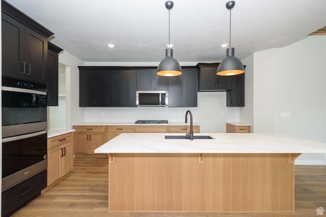 166 N Husker Ln, Saratoga Springs, UT 84045 - kitchen featuring stainless steel microwave, double wall oven, a sink, light wood-style floors, and recessed lighting