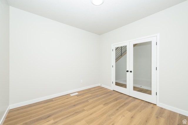 166 N Husker Ln, Saratoga Springs, UT 84045 - unfurnished room with baseboards, light wood finished floors, and french doors