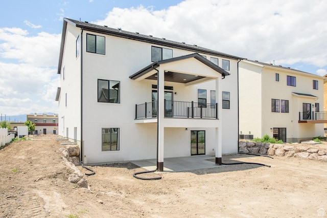 166 N Husker Ln, Saratoga Springs, UT 84045 - rear view of property with a balcony, stucco siding, and a patio area