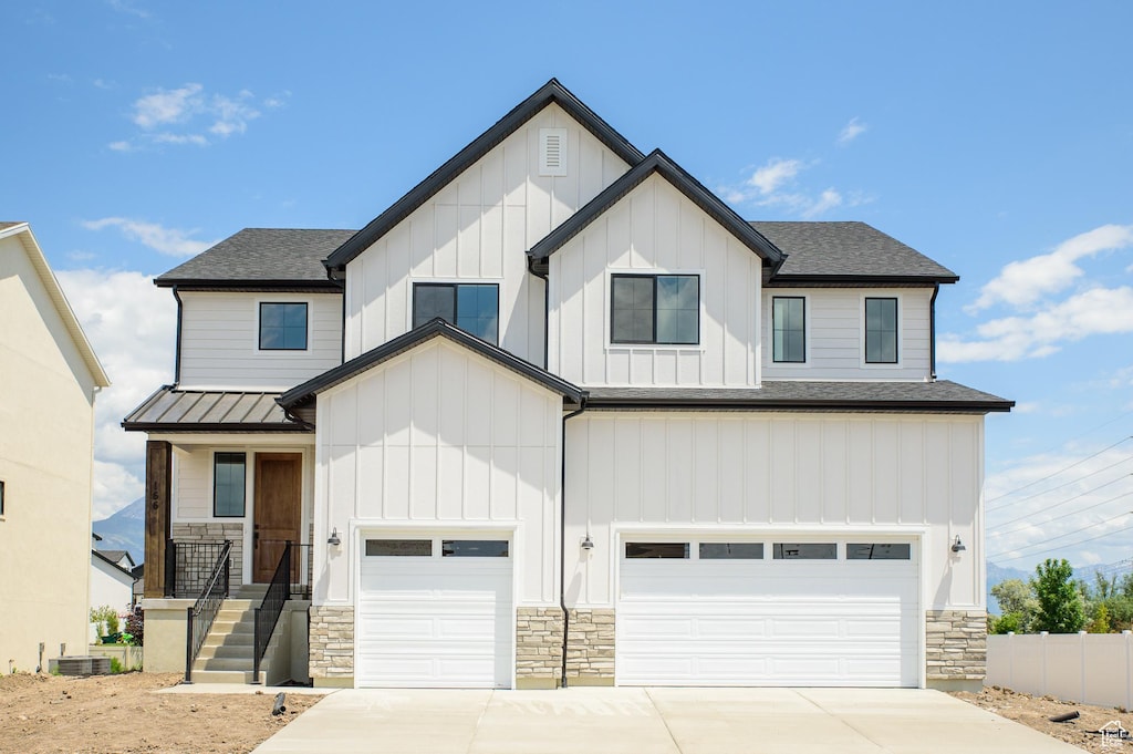 166 N Husker Ln, Saratoga Springs, UT 84045 - view of front of property with an attached garage, stone siding, board and batten siding, and driveway