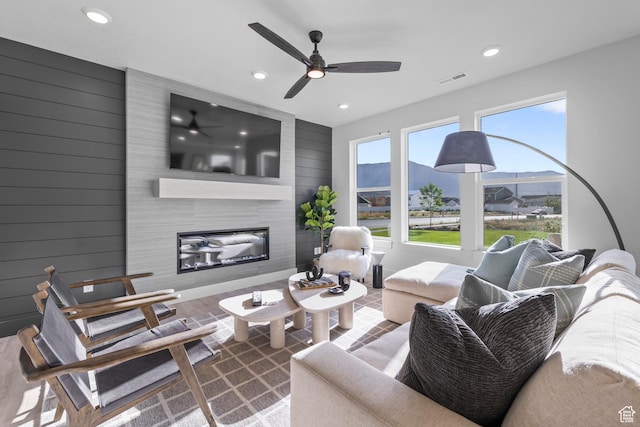 3164 N 3500 W, Plain City, UT 84404 - living area with recessed lighting, a fireplace, ceiling fan, wooden walls, and wood finished floors