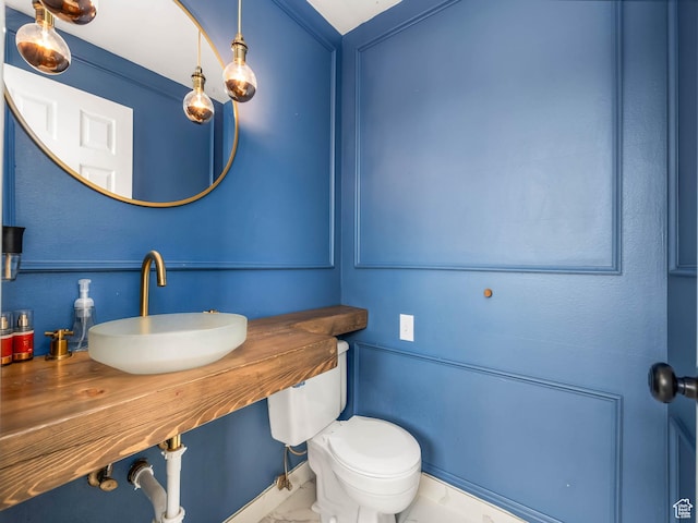 167 N 750 E, Orem, UT 84097 - half bathroom featuring a sink, toilet, and marble look tile flooring