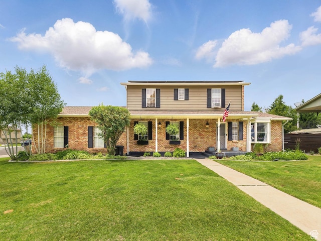 167 N 750 E, Orem, UT 84097 - traditional-style home with brick siding, a front yard, and covered porch