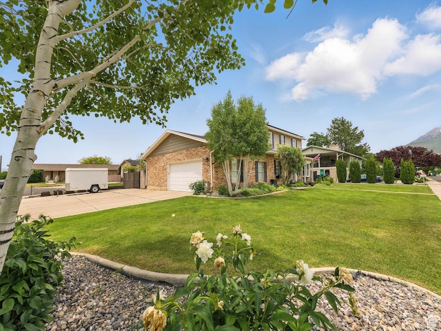 167 N 750 E, Orem, UT 84097 - view of front of house with brick siding, a front lawn, concrete driveway, and a garage