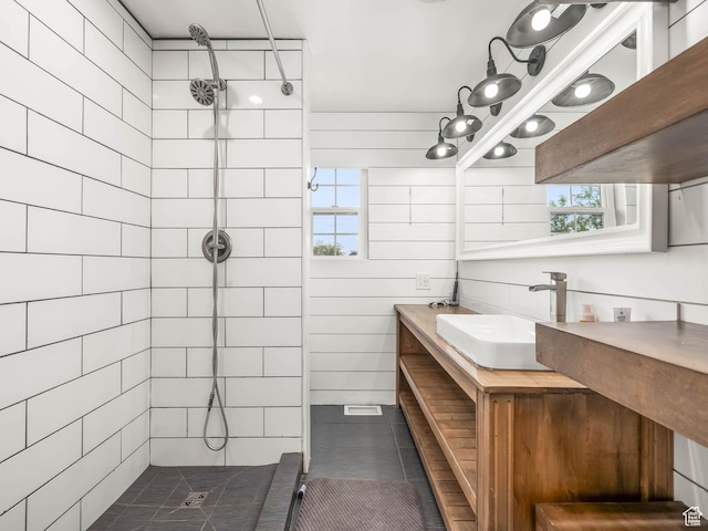 167 N 750 E, Orem, UT 84097 - bathroom featuring a tile shower, plenty of natural light, vanity, and tile patterned flooring