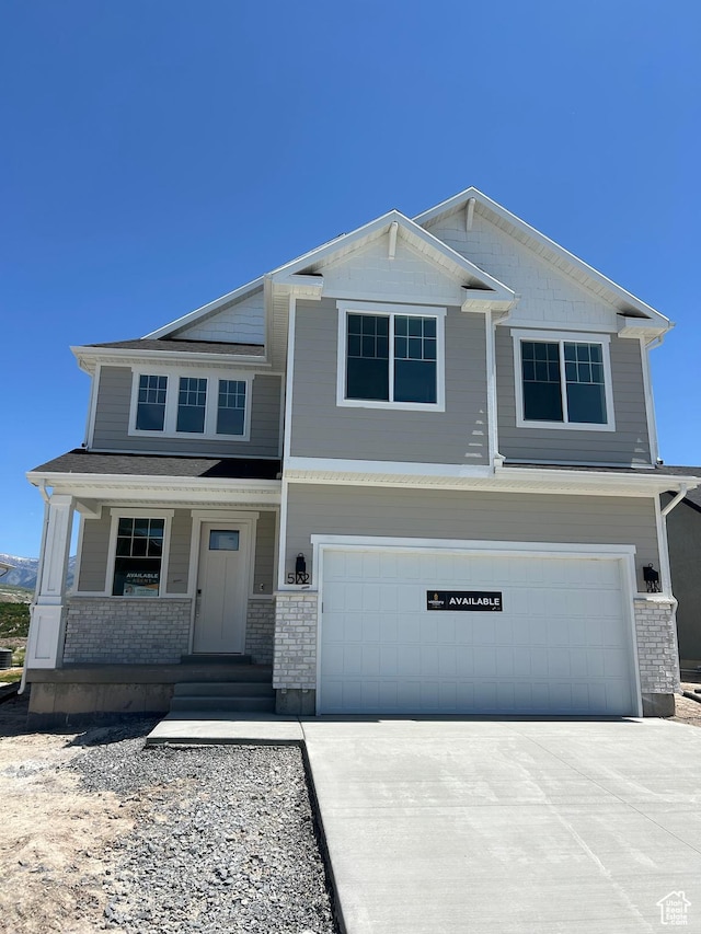 572 N 600 W, Smithfield, UT 84335 - view of front of house featuring an attached garage, concrete driveway, a porch, and brick siding