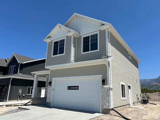 572 N 600 W, Smithfield, UT 84335 - view of front of property with an attached garage, central AC unit, concrete driveway, and a mountain view