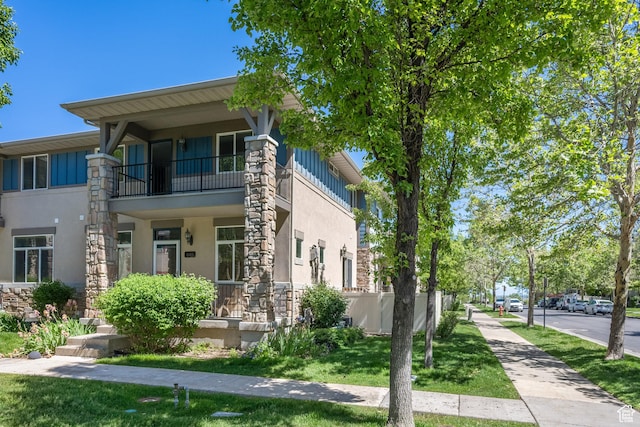 11411 S Oakmond Rd, South Jordan, UT 84009 - view of front of property featuring a balcony, stucco siding, and stone siding