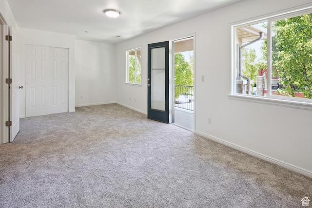 11411 S Oakmond Rd, South Jordan, UT 84009 - unfurnished bedroom featuring access to outside, multiple windows, and carpet