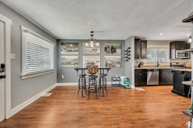 763 E Spring View Dr, Millcreek, UT 84106 - dining space with a textured ceiling, wood finished floors, and recessed lighting
