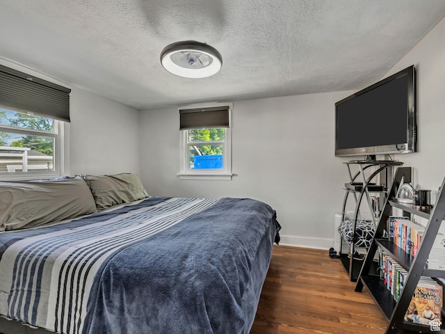 763 E Spring View Dr, Millcreek, UT 84106 - bedroom with multiple windows, wood finished floors, and a textured ceiling