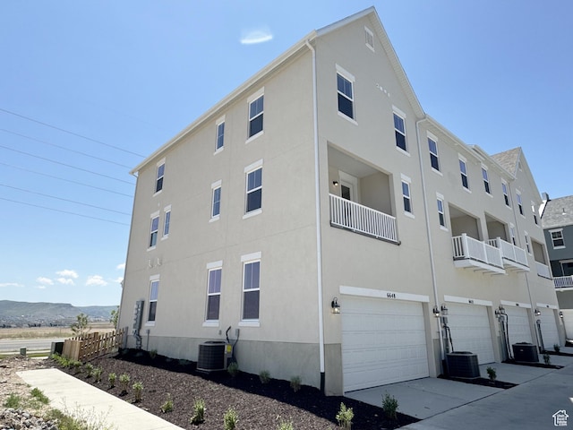 6648 W 11800 S, South Jordan, UT 84009 - view of building exterior featuring an attached garage and central AC unit