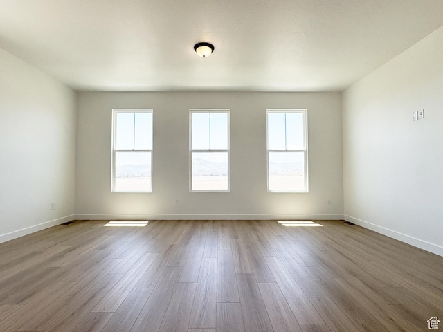 6648 W 11800 S, South Jordan, UT 84009 - unfurnished room with healthy amount of natural light, wood finished floors, and baseboards