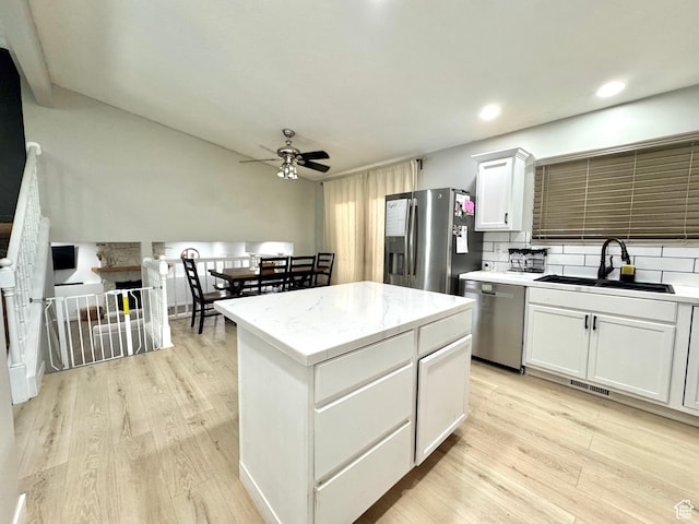 574 N Jackson Ave, Ogden, UT 84404 - kitchen featuring stainless steel appliances, a sink, ceiling fan, light wood-style floors, and white cabinets