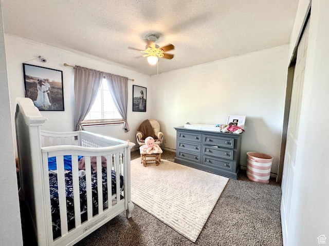 574 N Jackson Ave, Ogden, UT 84404 - bedroom with dark carpet, a crib, a textured ceiling, and ceiling fan