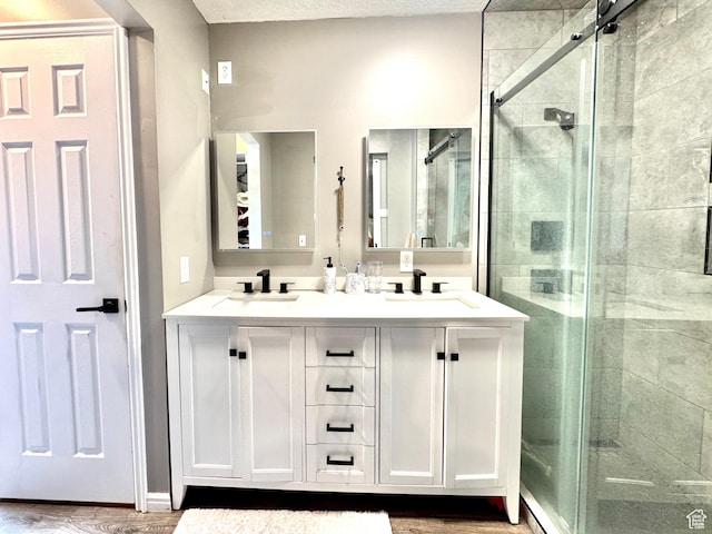 574 N Jackson Ave, Ogden, UT 84404 - bathroom featuring a stall shower, double vanity, and wood finished floors
