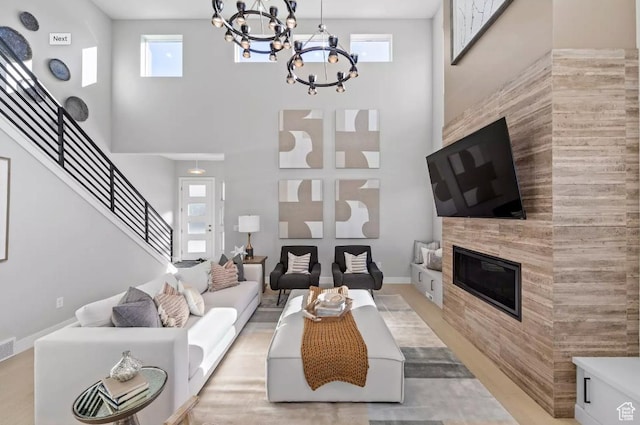 5877 N Canyon Rim Rd Unit 623, Lehi, UT 84043 - living room with a chandelier, a towering ceiling, stairway, plenty of natural light, and a tile fireplace