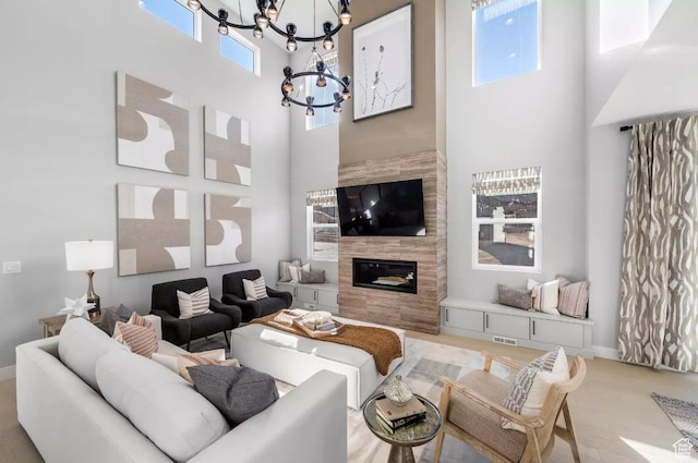 5877 N Canyon Rim Rd Unit 623, Lehi, UT 84043 - living room with a towering ceiling, a chandelier, a tiled fireplace, and baseboards