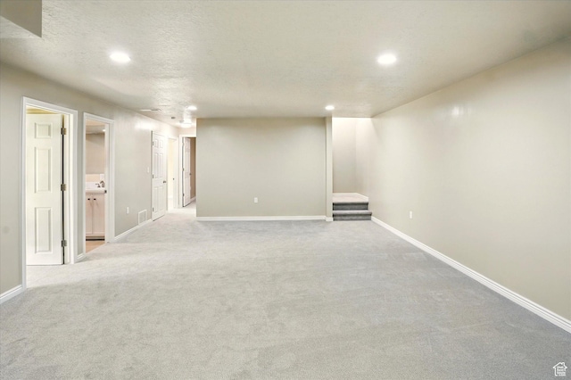11569 S Oakmond Rd, South Jordan, UT 84009 - finished below grade area with recessed lighting, baseboards, carpet flooring, stairway, and a textured ceiling