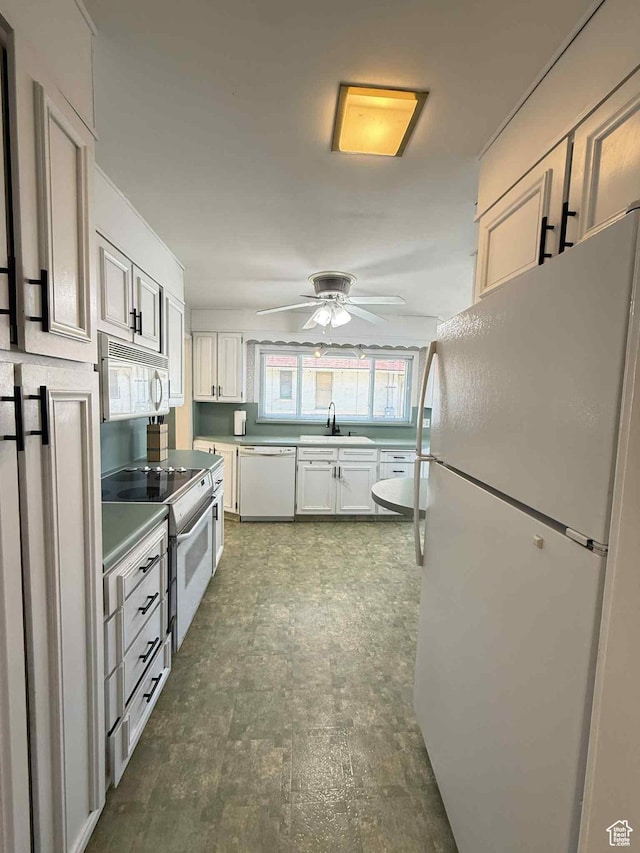 229 N Carbon Ave, Price, UT 84501 - kitchen featuring white appliances, a sink, a ceiling fan, white cabinetry, and dark floors