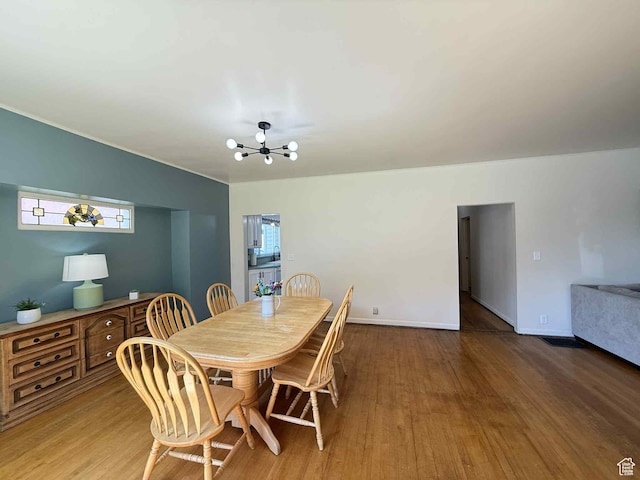 229 N Carbon Ave, Price, UT 84501 - dining area with a chandelier, wood finished floors, and baseboards