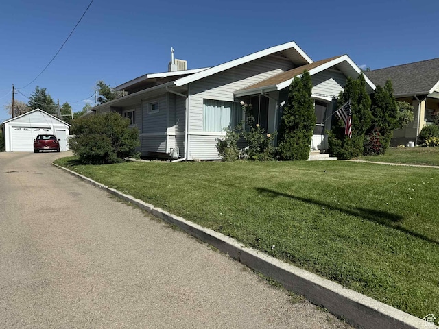 229 N Carbon Ave, Price, UT 84501 - view of front facade featuring a garage, an outbuilding, and a front lawn