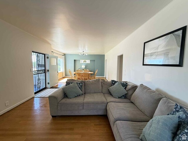229 N Carbon Ave, Price, UT 84501 - living area featuring dark wood finished floors, a chandelier, and baseboards