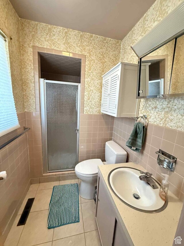 229 N Carbon Ave, Price, UT 84501 - full bath with tile walls, wallpapered walls, toilet, a shower stall, and vanity