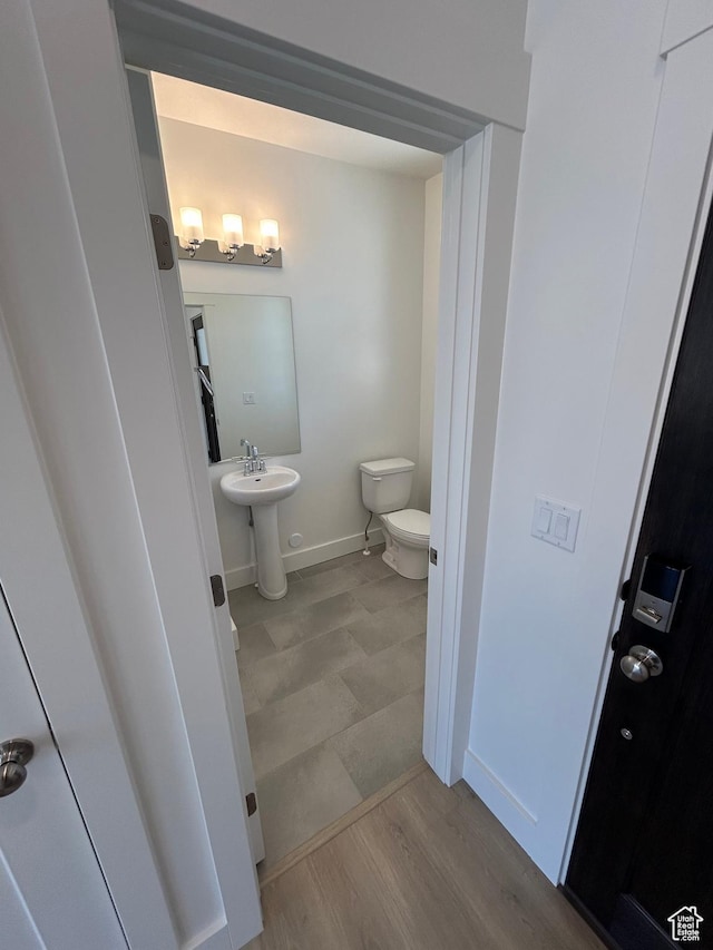 554 N 800 W, Smithfield, UT 84335 - bathroom featuring toilet, baseboards, wood finished floors, and a sink