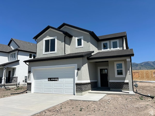 554 N 800 W, Smithfield, UT 84335 - view of front facade featuring a garage, stucco siding, driveway, and a mountain view