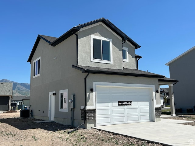 554 N 800 W, Smithfield, UT 84335 - view of side of home featuring a garage, driveway, and stucco siding
