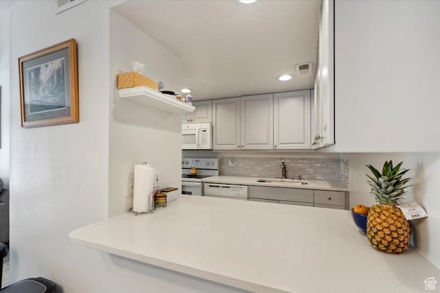 2631 W 5625 S, Roy, UT 84067 - kitchen with white appliances, a sink, light countertops, tasteful backsplash, and recessed lighting